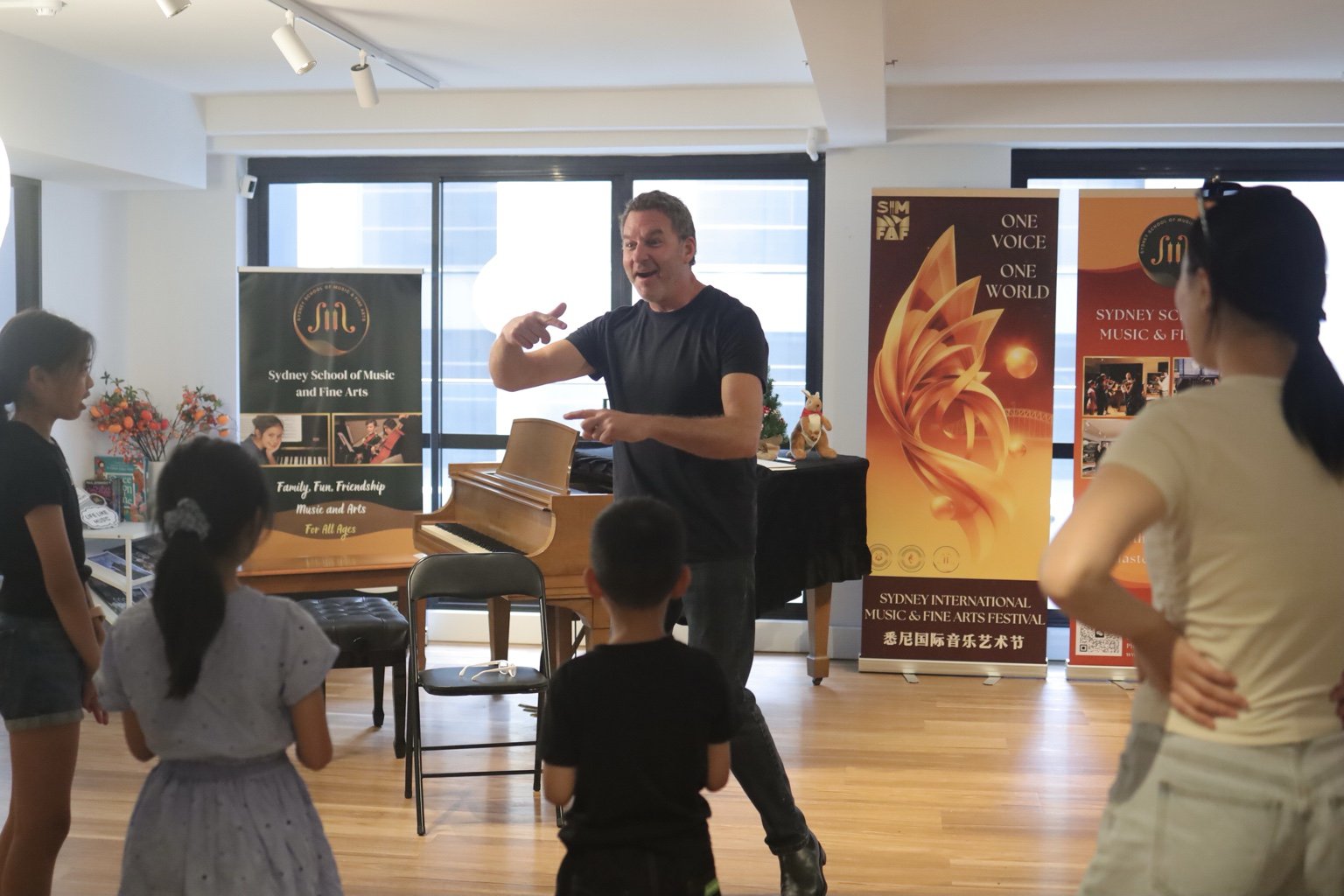Festival educator with students in a Sydney studio with Festival banners